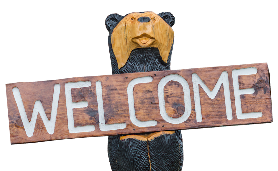 Bear Statue holding Welcome sign